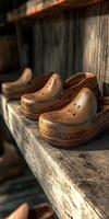 Wooden clogs displayed on rustic wooden shelf in cozy setting photo