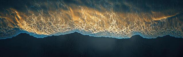 A wave of water is shown in the dark photo