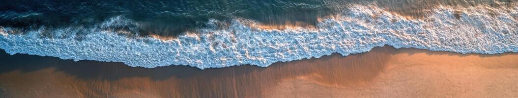 Waves gently lapping on a serene shoreline at sunset photo