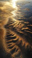 Waves and patterns at shoreline during sunset glow photo