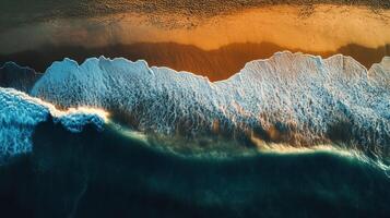 Waves gently crash on a serene shoreline at sunset photo