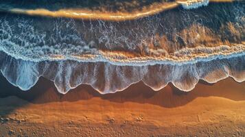 Aerial view of waves crashing on the beach photo