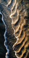 Calm shoreline waves create patterns at sunset photo