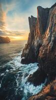 A rocky cliff with water and a sunset photo