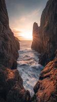 Sunset over the rocky cliff photo