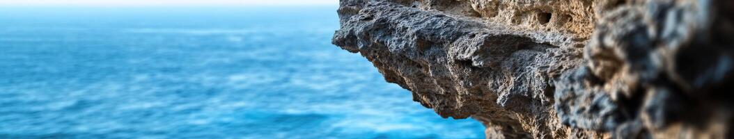 A person is standing on the edge of a cliff photo