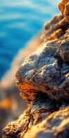 A close up of rocks on the shore of the ocean photo