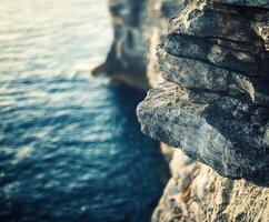A person standing on the edge of a cliff photo