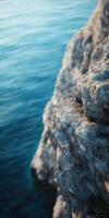 Rocky shoreline against blue water photo