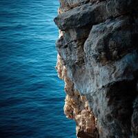 Cliff overlooking deep blue ocean photo