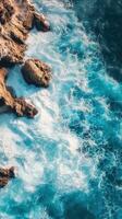 An aerial view of the ocean and rocks photo