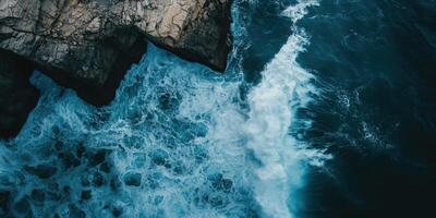 An aerial view of the ocean and rocks photo