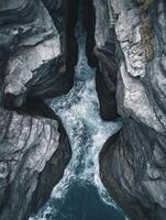 Rocky coastal canyon with waves photo