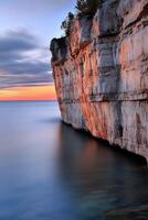 Sunset over the calm cliff edge photo