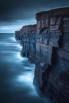 Ocean waves crash against cliffs photo