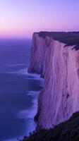 Majestic coastal cliff at dusk photo