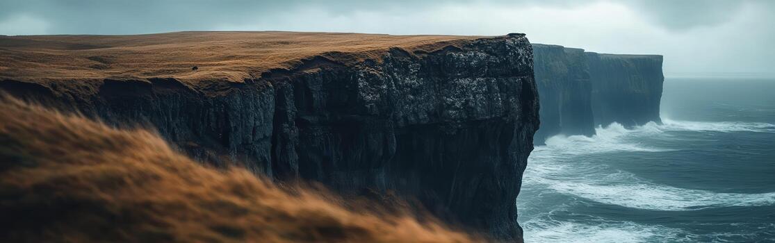 A large cliff with a large ocean in the background photo