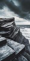 Rocky coastline with dark clouds photo