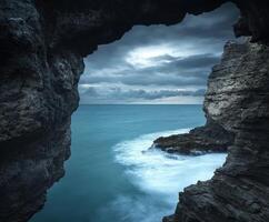 Coastal rock formation under cloudy sky photo