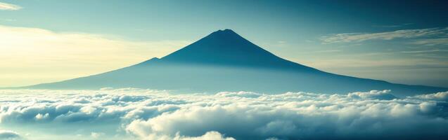 View of a mountain above clouds photo