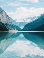 A lake surrounded by mountains and trees photo