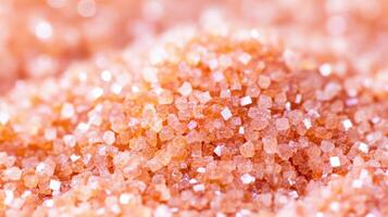 Pink sugar granules close up photo