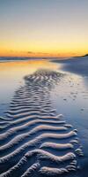 Sunset at the beach with waves and sand photo
