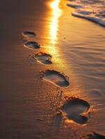Footprints on the beach at sunset photo