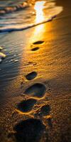 Footprints in golden sand photo