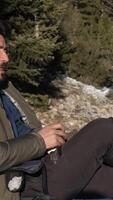 Man resting and drink coffe in snow video