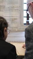 Man and boy reading quran video