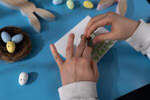 Drawing Easter rabbit bunny Storytelling of creating craft Easter greeting card holiday present. Tactile hand-on activity. Master class progress of creative me-made gifts. Seasonal domestic life micro moment hobby. Sustainable living photo