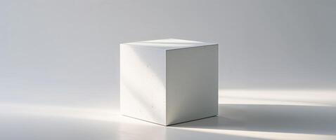 White cube bathed in light with textured surface stands still. photo