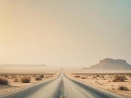 Desert Highway Stretching into the Horizon with Hazy Atmosphere and Sparse Vegetation. photo