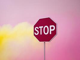 A stop sign with a yellow cloud in the background photo