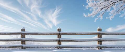 A fence with snow on it and a tree in the background photo
