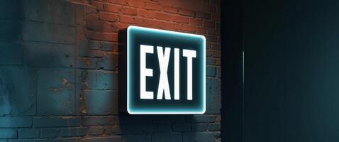 A neon exit sign on a brick wall photo
