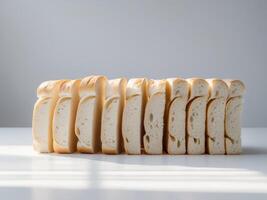 White Bread Slices Neatly Arranged on Table photo