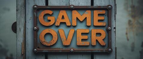 Rusty game over sign spelling the end of the fun photo