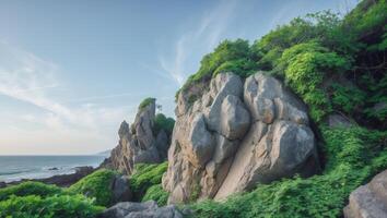 Majestic rock formation meets lush vegetation under a serene coastal sky photo