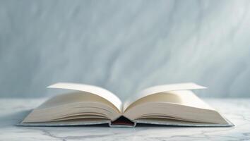 Open book on marble surface showcasing blank pages in serene setting. photo