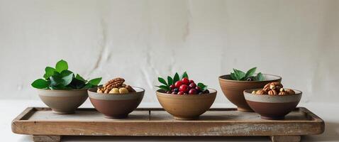A wooden tray with four bowls of food on it. photo