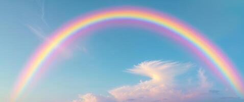 A rainbow is seen in the sky with clouds photo