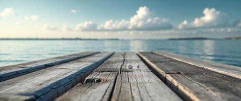 A wooden dock with a blue sky and clouds in the background photo