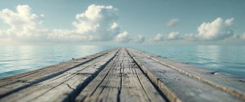 A wooden pier over the ocean with clouds in the sky photo