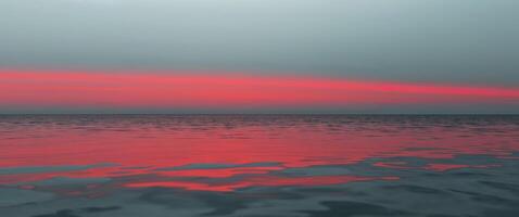 Red Horizon Line Reflecting On Dark Water. photo