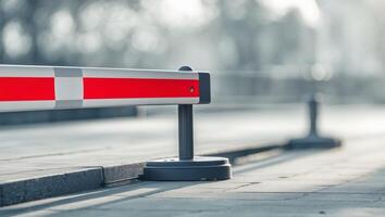 Traffic barrier with red and white stripes on footpath blurred background and ample copy space for transportation and safety concepts. photo