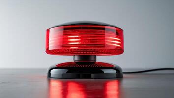 Bright Red Emergency Light with Glossy Black Base for Safety and Security Applications. photo