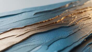 Abstract textured surface with gradient hues of metallic gold and blue photo