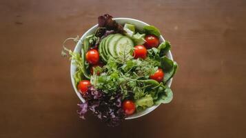 A bowl of salad with tomatoes, lettuce and avocado photo